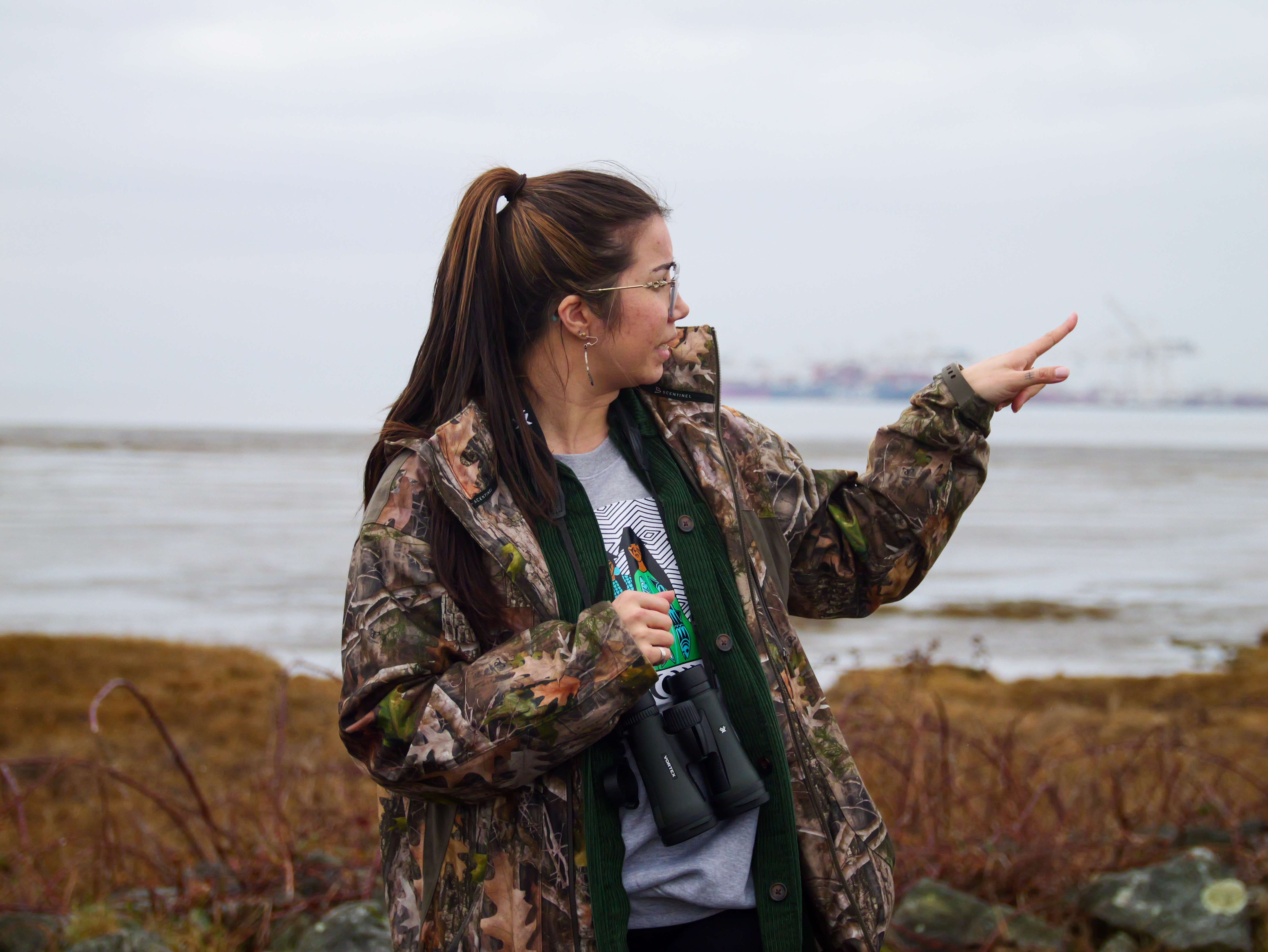 Tsawwassen youth pointing out bird species along the shore